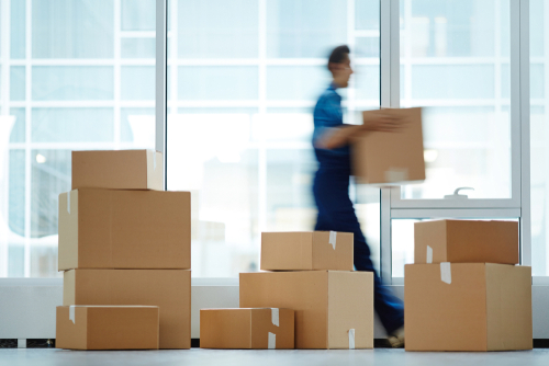 Blurred Motion Of Contemporary Worker With Packed Box Walking To business movers san diego